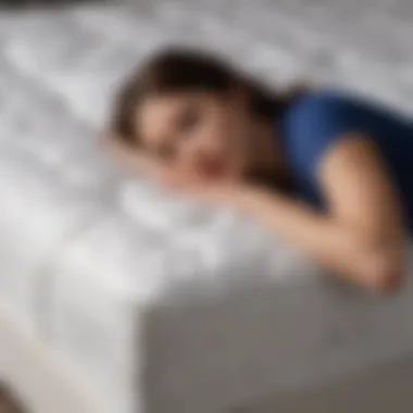 Person enjoying restful sleep on the mattress topper