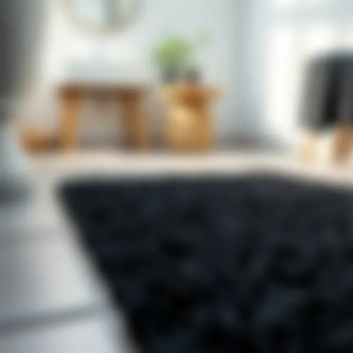 Close-up view of textured black bathroom rug on tiled floor